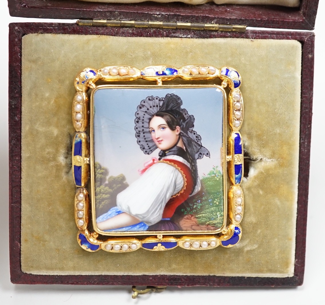 A cased Swiss? yellow metal, enamel and seed pearl mounted enamelled portrait brooch, 48mm, 13.8 grams.